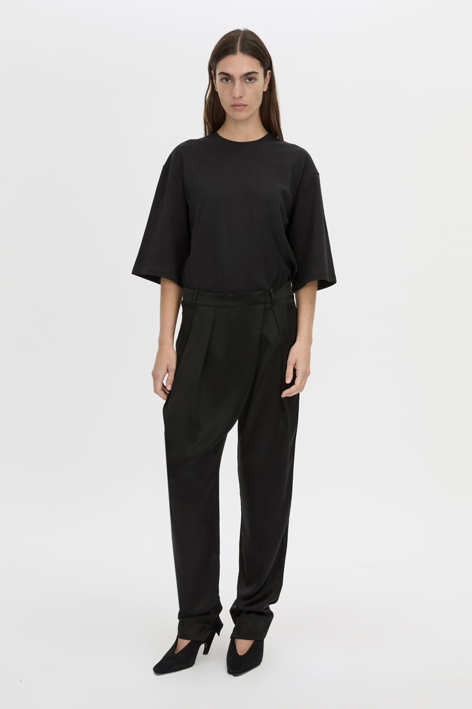 Front-styled view CAMILLA AND MARC Velin Pant in black with pleated bow‑leg design.