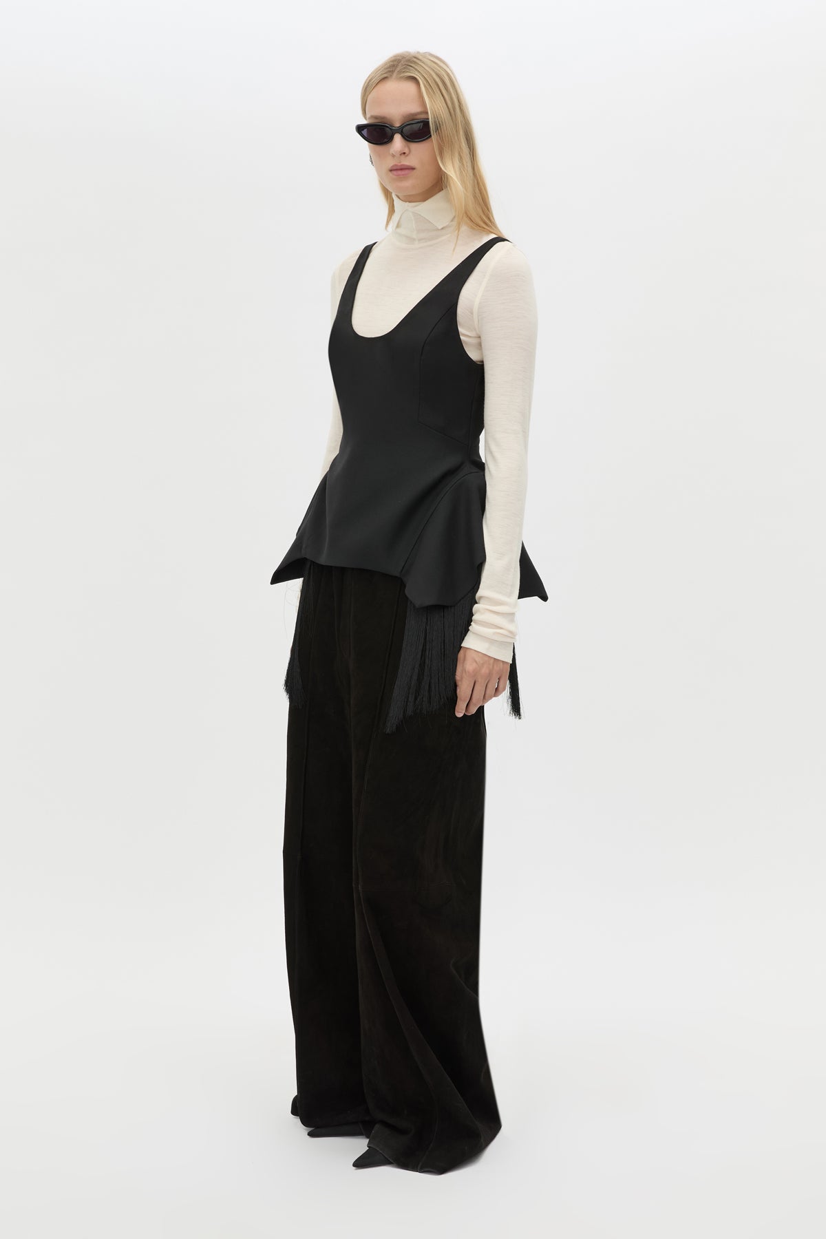 Three-quarter view CAMILLA AND MARC Zaman Top in Black with a structured sleeveless design and detachable hem fringe.