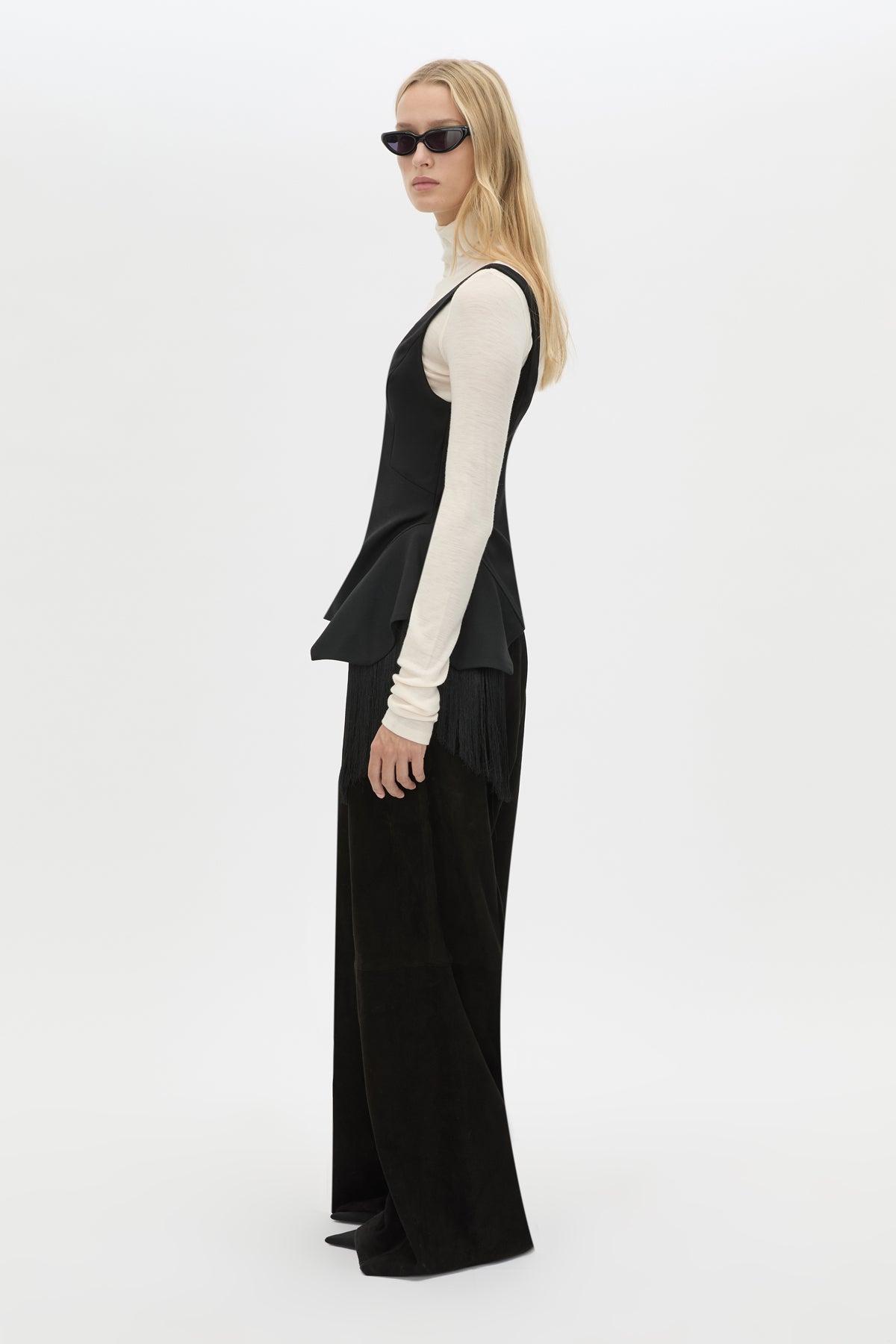Side view CAMILLA AND MARC Zaman Top in Black with a structured sleeveless design and detachable hem fringe.