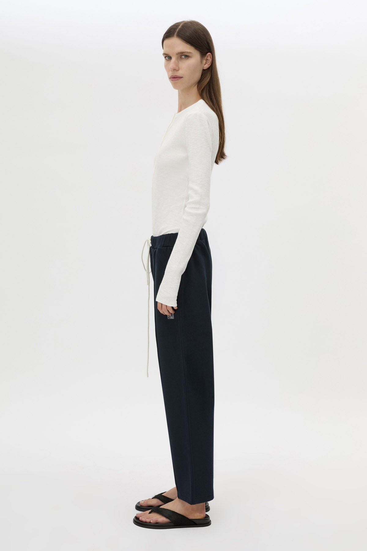 Side view CAMILLA AND MARC Zylus straight-leg tracksuit pant in navy with embroidered monogram.