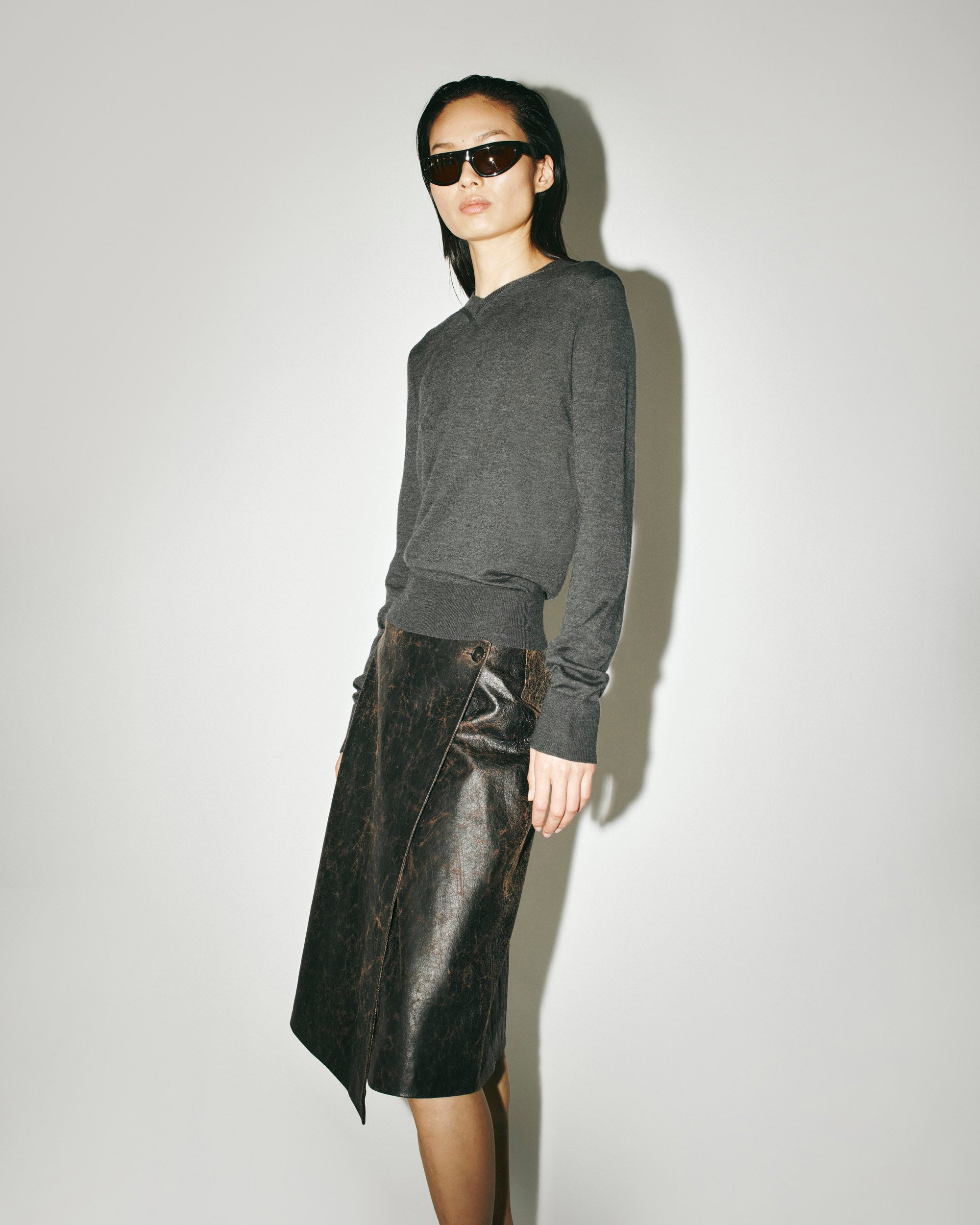 CAMILLA AND MARC AW26 - Leona V Neck Sweater in charcoal and Dawn Leather Skirt.