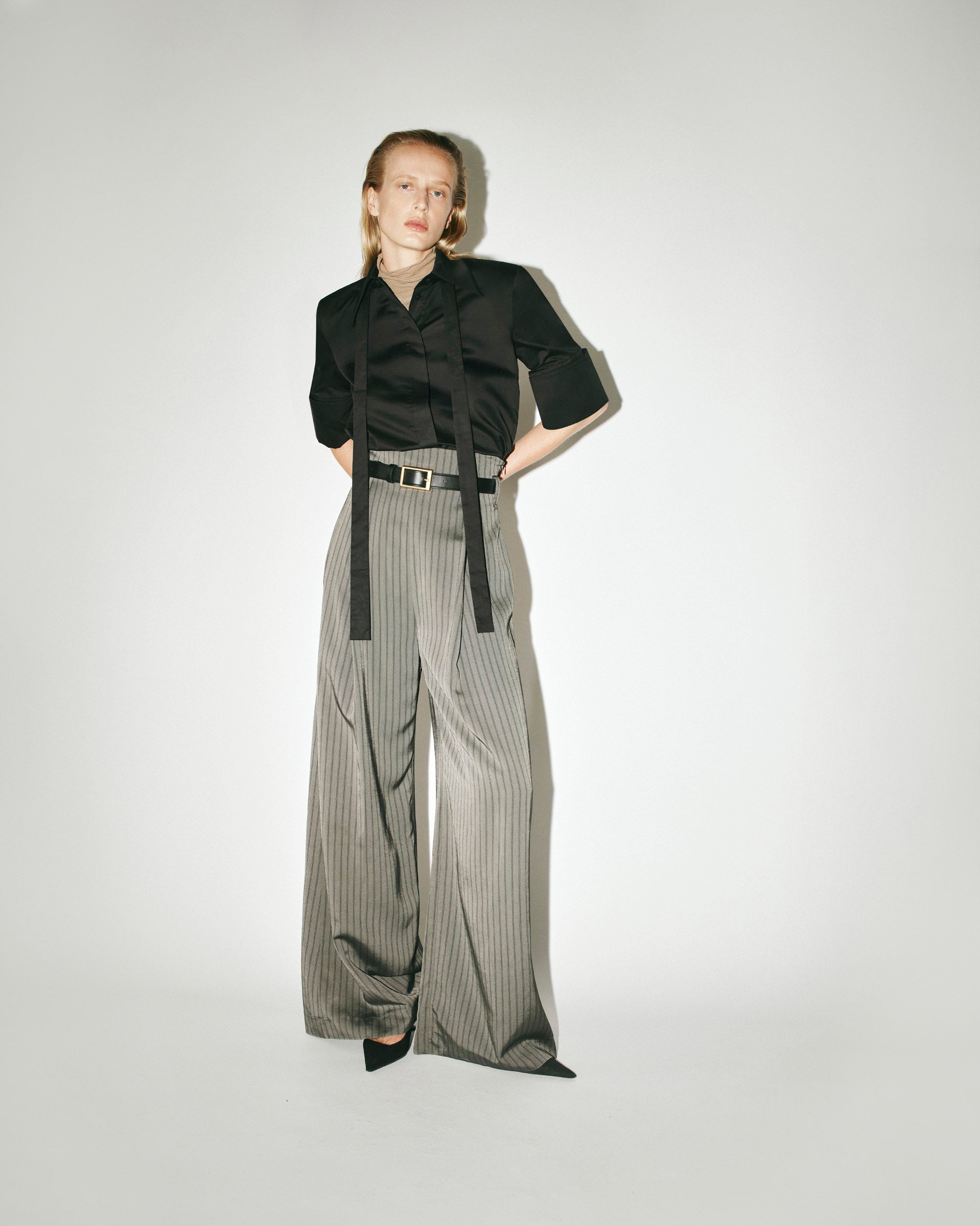 CAMILLA AND MARC AW26 Collection - Model wearing Pique Shirt in black and Mina Pant in grey.