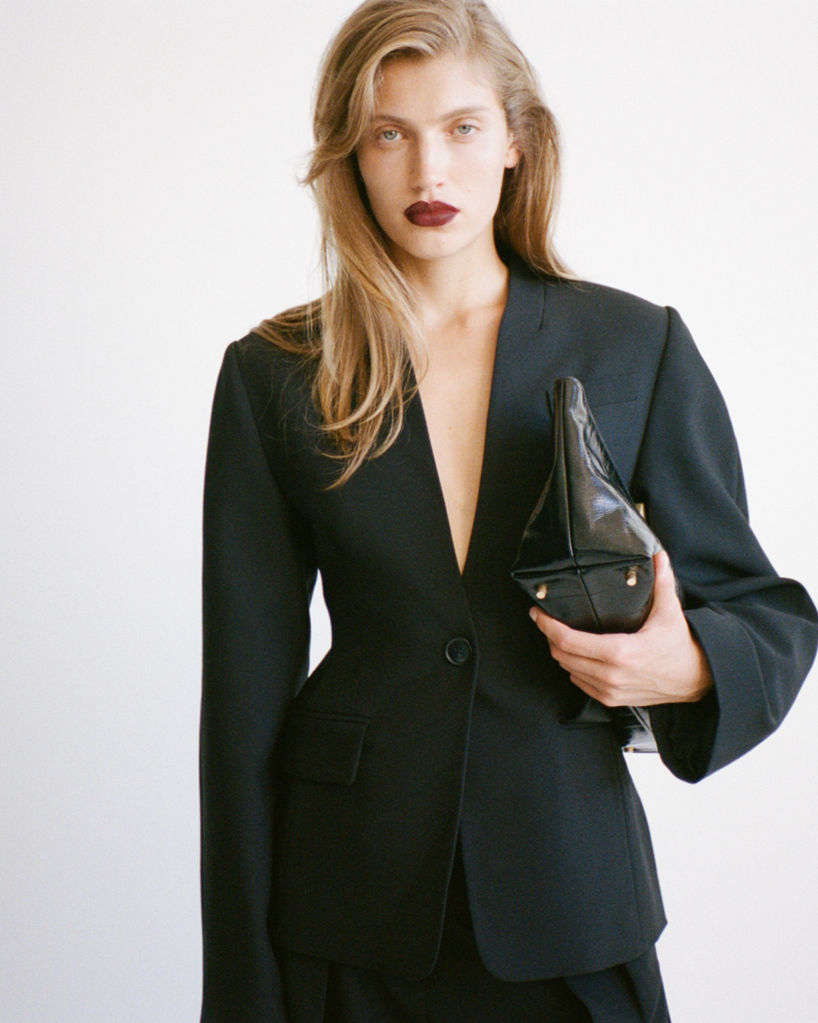 CAMILLA AND MARC PF26 - Tala Fitted Collarless Blazer holding Poppy Eel Clutch