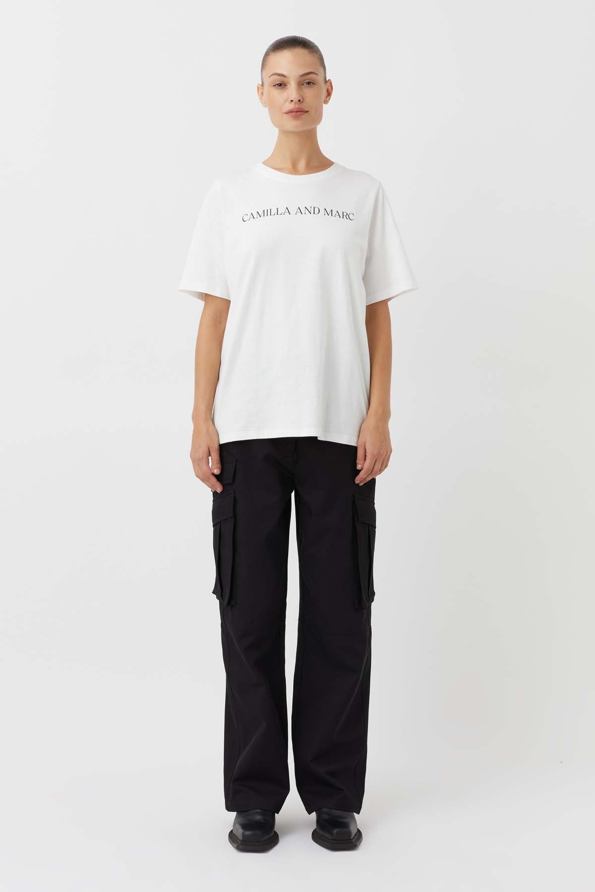 CAMILLA AND MARC Asher Cotton Logo Tee in White.

The Asher Tee seamlessly blends comfort and style, making it a perfect choice for any casual occasion. This tee is crafted from premium quality cotton and promises a soft and breathable feel, ensuring all-day comfort. The relaxed fit and logo elevate this tee making it an instant wardrobe hero.