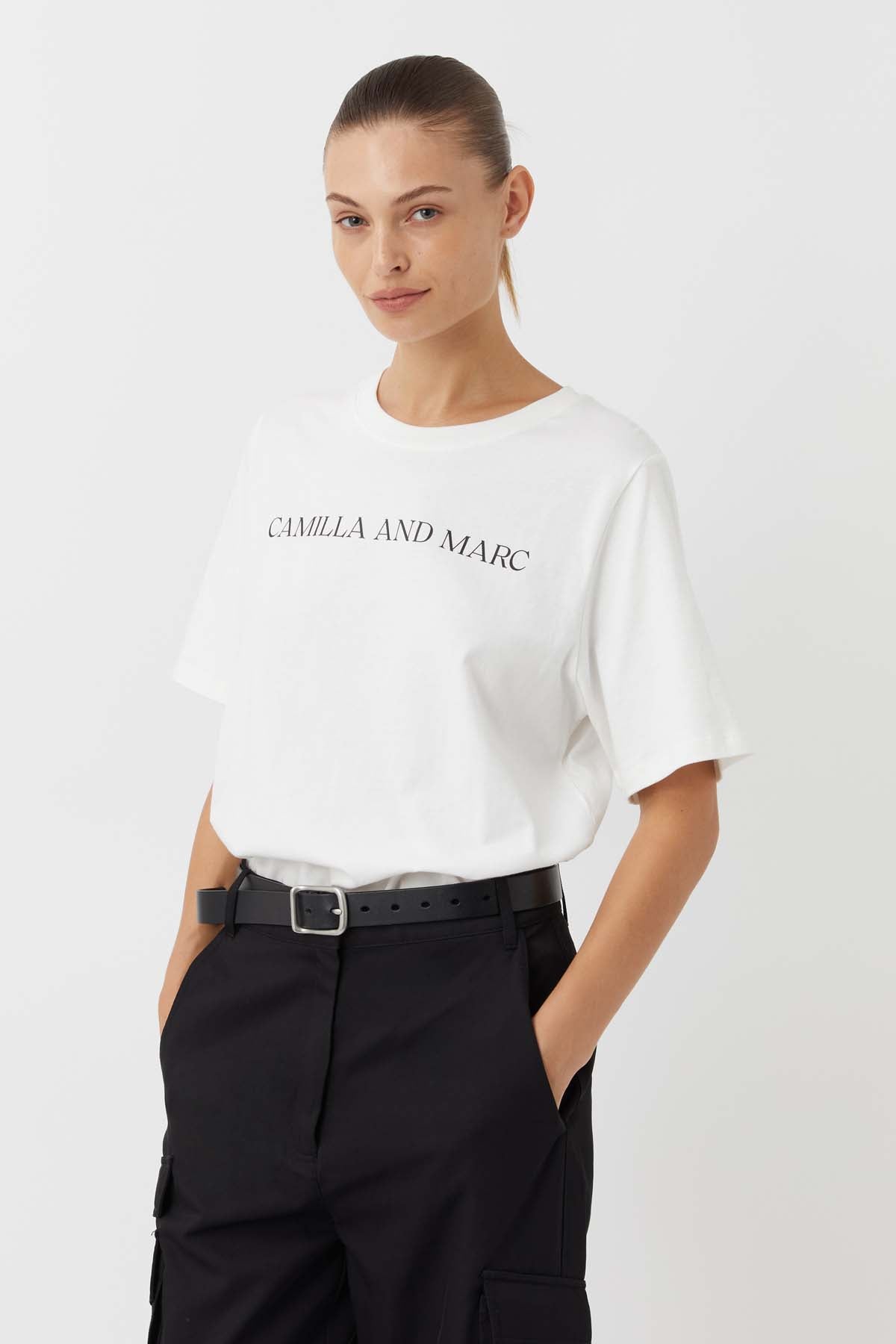 CAMILLA AND MARC Asher Cotton Logo Tee in White.

The Asher Tee seamlessly blends comfort and style, making it a perfect choice for any casual occasion. This tee is crafted from premium quality cotton and promises a soft and breathable feel, ensuring all-day comfort. The relaxed fit and logo elevate this tee making it an instant wardrobe hero.