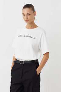 CAMILLA AND MARC Asher Cotton Logo Tee in White.

The Asher Tee seamlessly blends comfort and style, making it a perfect choice for any casual occasion. This tee is crafted from premium quality cotton and promises a soft and breathable feel, ensuring all-day comfort. The relaxed fit and logo elevate this tee making it an instant wardrobe hero.